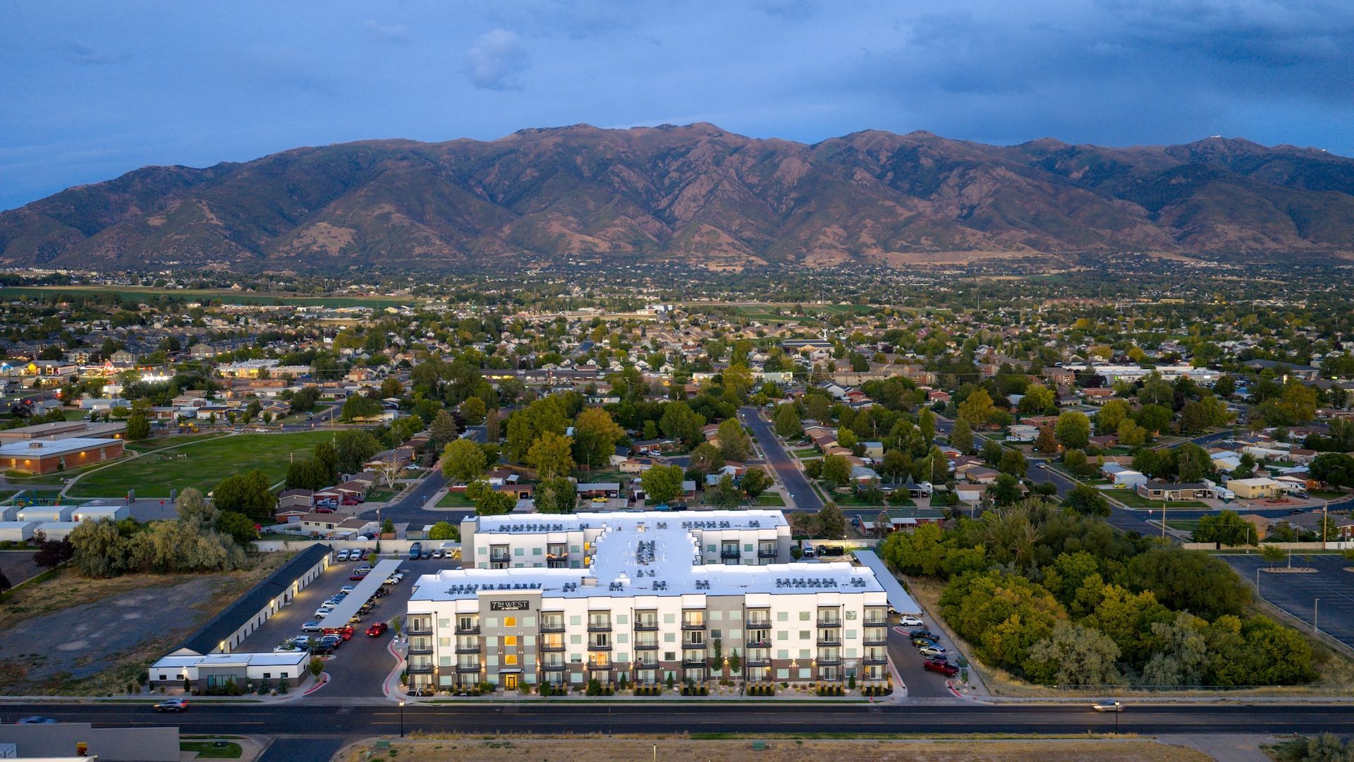 Aerial view of 7th West at Midtown with mountains at dusk